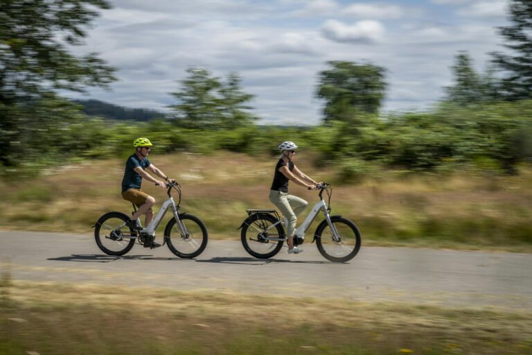 A Couple Bicycling Fast on a Rural Road